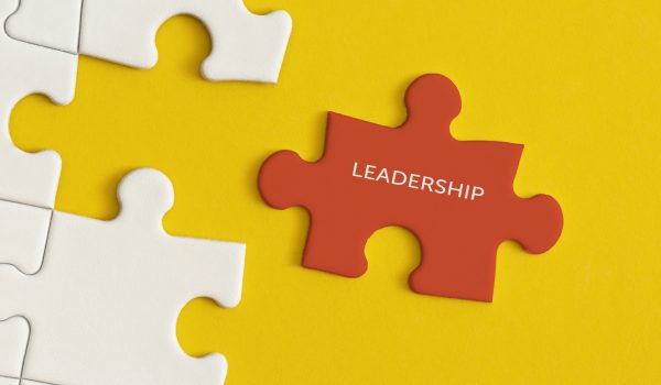 White details of puzzle on yellow background. Business strategy, teamwork, leadership.